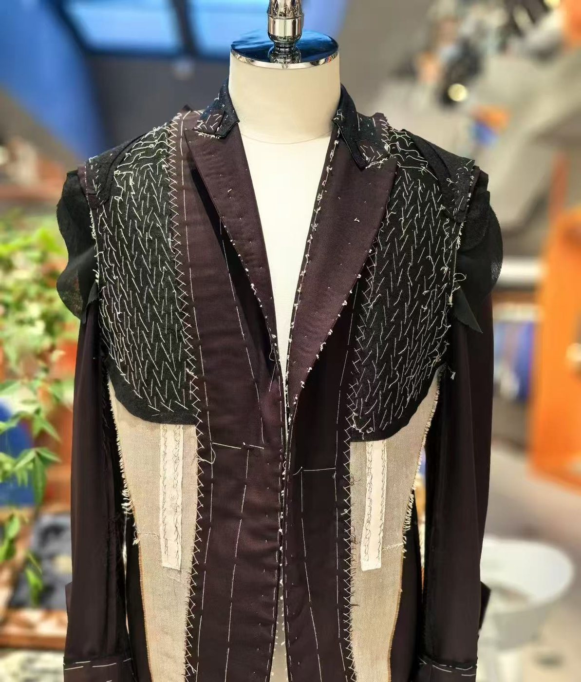 Hand-padded chest and lapel canvas, the stitch rows uneven in spacing and shifting in angle from row to row